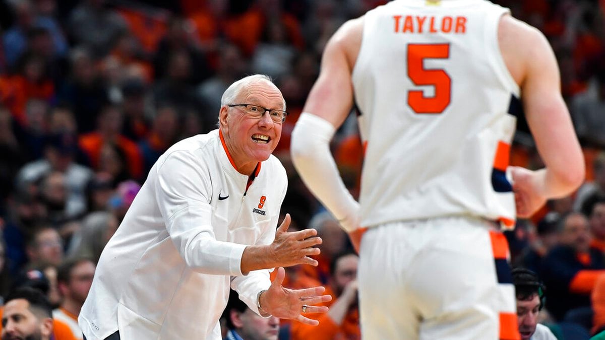 Syracuse head coach Jim Boeheim, left, gives instructions to guard Justin Taylor during the...